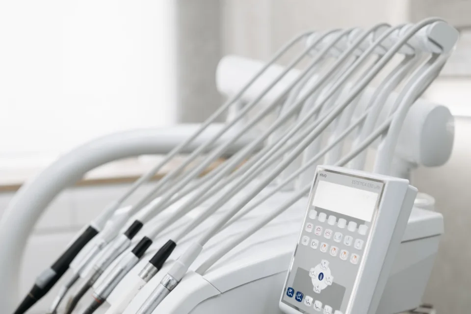 Close-up of modern dental tools in a well-lit dental office, emphasizing advanced healthcare technology.